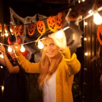 Two people hanging Halloween decorations